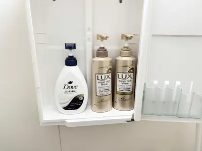 three bottles ofodorizers sit in a bathroom cabinet at Waseda University area 3F6 with elevator in Tokyo