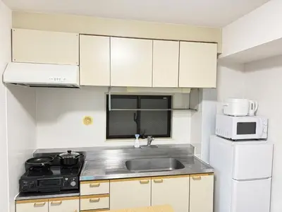 a small kitchen with a sink and a microwave at Waseda University area 3F6 with elevator in Tokyo