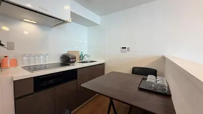 a small kitchen with a table and a sink at YIYou Japan\u79cb\u8449\u539f401 in Tokyo