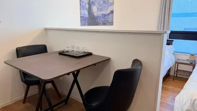 a room with a table and two chairs and a bed at YIYou Japan\u79cb\u8449\u539f401 in Tokyo