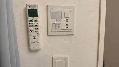 a remote control on a wall next to a door at YIYou Japan\u79cb\u8449\u539f401 in Tokyo