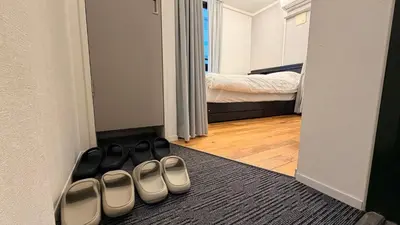 a pair of shoes on the floor of a bedroom at YIYou Japan\u79cb\u8449\u539f401 in Tokyo