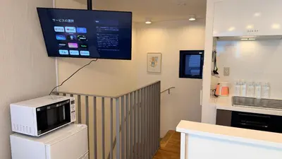 a kitchen with a microwave and a tv on the wall at YIYou Japan\u79cb\u8449\u539f401 in Tokyo