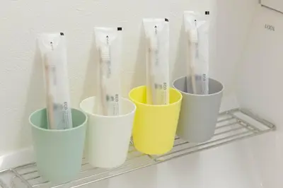a group of cups sitting on a shelf in a refrigerator at AMBLE Asakusa in Tokyo