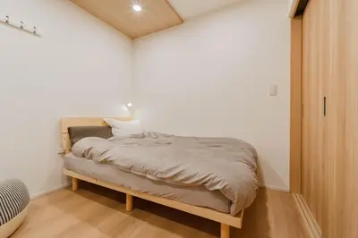 a small bedroom with a bed in the corner at AMBLE Asakusa in Tokyo
