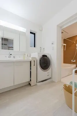 a bathroom with a sink and a washing machine at AMBLE Asakusa in Tokyo