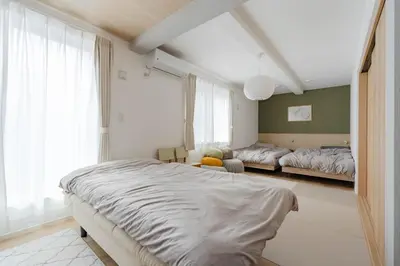 a bedroom with two beds and a window at AMBLE Asakusa in Tokyo