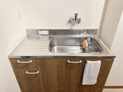 a stainless steel sink in a small kitchen at The Travelers Court Bunkyo III in Tokyo