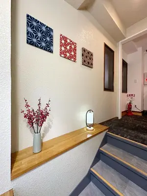a hallway with a vase of flowers on a wall at The Travelers Court Bunkyo III in Tokyo