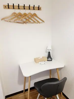 a white desk with a black chair and a lamp at The Travelers Court Bunkyo III in Tokyo