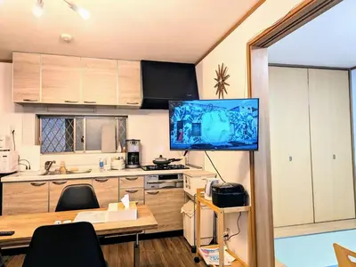 a kitchen with a large television on a table at Wood River House \u9580\u524d\u4ef2\u753a\u99c5 \u6728\u5834\u99c5 in Tokyo