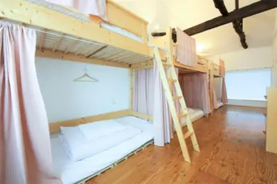 a bunk bed in a room with a ladder at Sato-san's Rest in Tokyo