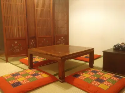 a room with a wooden table and two rugs at Sato-san's Rest in Tokyo