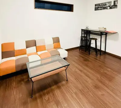 a living room with a couch and a table at \u72ec\u7acb\u5355\u95f430\u5e73\u65b9\u76f4\u8fbe\u4e0a\u91ce\u6d45\u8349\u94f6\u5ea7\u65b0\u5bbfNexus Villa Morishita in Tokyo