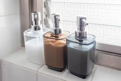 three bottles of liquid sitting on a window sill at WASABI Shibuya in Tokyo