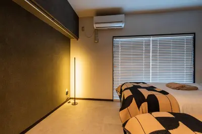 a bedroom with a bed and a large window at WASABI Shibuya in Tokyo