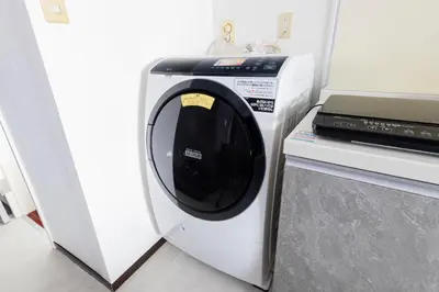 a washing machine sitting next to a microwave at WASABI Shibuya in Tokyo