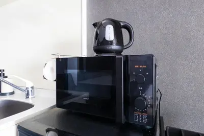a microwave with a coffee pot on top of it at WASABI Shibuya in Tokyo
