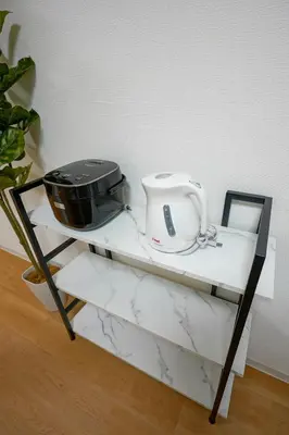 a black and white shelf with a appliance on it at BT House Bentencho Shinjuku Waseda in Tokyo