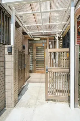 an entrance to a building with a wooden gate at BT House Bentencho Shinjuku Waseda in Tokyo