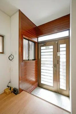 a pivot door in a room with wood at BT House Bentencho Shinjuku Waseda in Tokyo