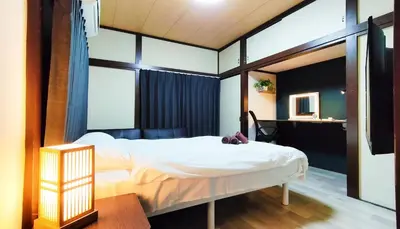 a bedroom with a white bed and a desk at \u7f8e-yahiro- in Tokyo