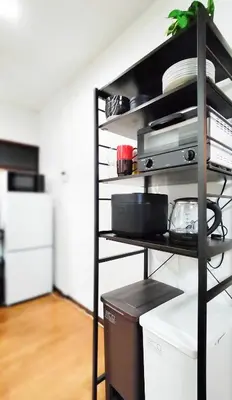 a kitchen with a shelf with dishes on it at \u7f8e-yahiro- in Tokyo