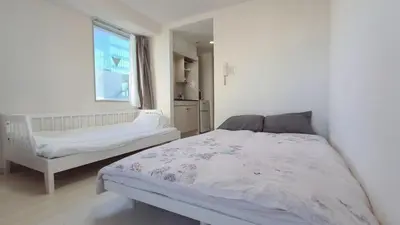 a white bedroom with a bed and a window at Ikebukuro center#\u6c60\u888b\u4e2d\u5fc3#\u9ad8\u7ea7\u9633\u5149\u516c\u5bd3\u8f66\u7ad9\u6b65\u884c5\u5206#\u9ad8\u901fwifi1208 in Tokyo