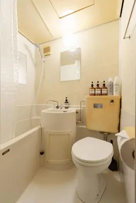 a white bathroom with a toilet and a sink at Maison Shin Nakano 201 MS21 in Tokyo