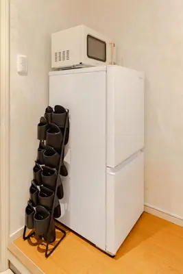 a white refrigerator with a microwave on top of it at Maison Shin Nakano 201 MS21 in Tokyo