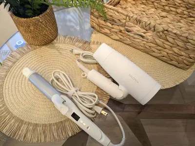 a hair dryer and a straw hat on a table at Nuan Stay Tokyo in Tokyo