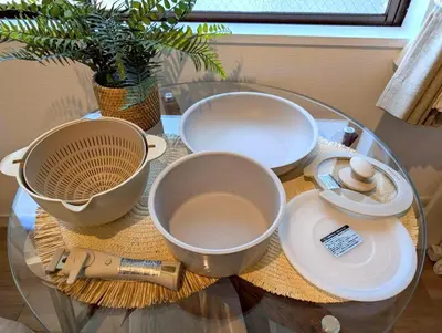 a glass table with two bowls and plates on it at Nuan Stay Tokyo in Tokyo