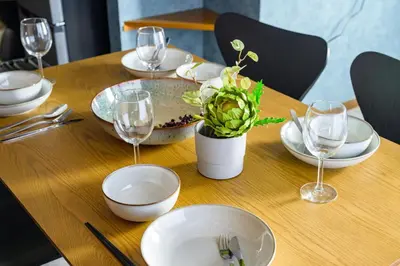 a table with plates and glasses and a plant on it at Chill Place 124 Horikiri Shobuen in Tokyo