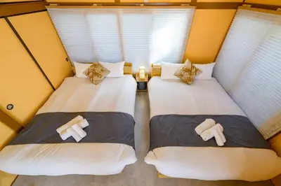 two twin beds in a small room with windows at Chill Place 124 Horikiri Shobuen in Tokyo