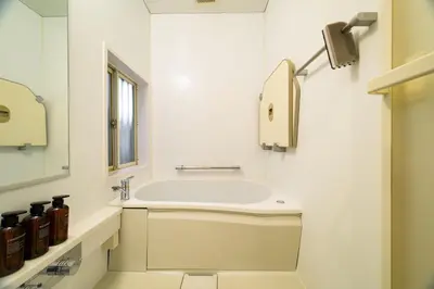 a white bathroom with a sink and a mirror at Chill Place 124 Horikiri Shobuen in Tokyo