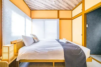 a bedroom with a large bed with a window at Chill Place 124 Horikiri Shobuen in Tokyo