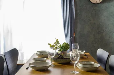a wooden table with plates and wine glasses on it at Chill Place 124 Horikiri Shobuen in Tokyo