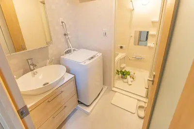 a bathroom with a sink and a toilet and a shower at New mansion within 10-min from Komagome in Tokyo
