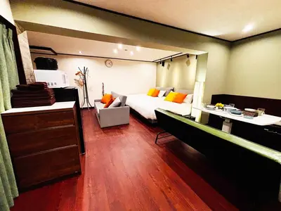 a bedroom with a bed and a couch in it at Shibuya 10 min Walk Theater & Garden Stay Max 6ppl in Tokyo