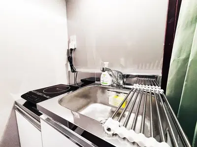 a kitchen sink with a drying rack next to it at Shibuya 10 min Walk Theater & Garden Stay Max 6ppl in Tokyo