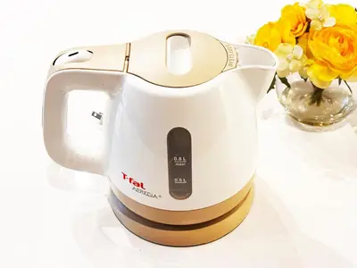 a tea kettle sitting next to a vase of flowers at Shibuya 10 min Walk Theater & Garden Stay Max 6ppl in Tokyo