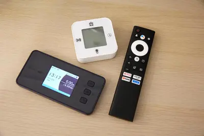 a remote control and an ipod next to a controller at 306 5 mins train to Roppongi , direct bus to Shibuya in Tokyo