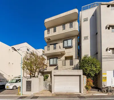an apartment building with a garage at 5-Min Walk to Yamanote Line, Newly Renovated APT in Prime Location, Quiet Neighborhood in Tokyo