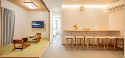 a room with a bar and a table and stools at 5-Min Walk to Yamanote Line, Newly Renovated APT in Prime Location, Quiet Neighborhood in Tokyo