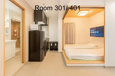 a room with two beds and a refrigerator at 5-Min Walk to Yamanote Line, Newly Renovated APT in Prime Location, Quiet Neighborhood in Tokyo
