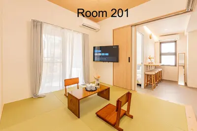 a living room with a table and chairs and a tv at 5-Min Walk to Yamanote Line, Newly Renovated APT in Prime Location, Quiet Neighborhood in Tokyo