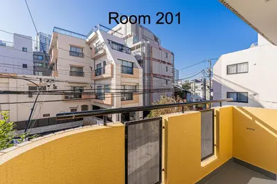 a yellow balcony in front of a building at 5-Min Walk to Yamanote Line, Newly Renovated APT in Prime Location, Quiet Neighborhood in Tokyo