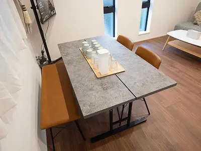 a table in a living room with chairs and a table at \u685c\u306e\u5ddd76 \u6c60\u888b\u99c5C6\u53e3 8\u5206 2-10\u4eba\u4e28Ikebukuro JR Line C6 Exit 8 minutes 2-10 people in Tokyo