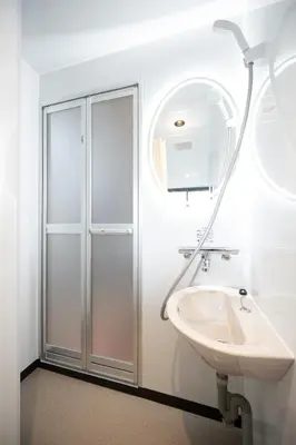 a bathroom with a shower and a sink at VillaŌyama 111 in Tokyo