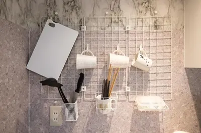 a wire rack with utensils in a bathroom at VillaŌyama 111 in Tokyo